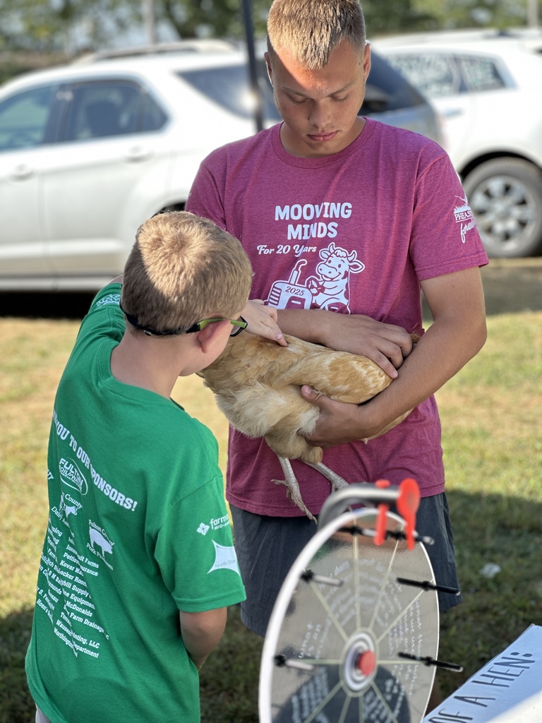 students posing with an animal