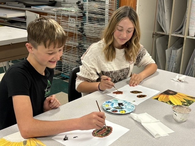 students painting in a classroom