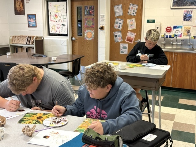students painting in a classroom