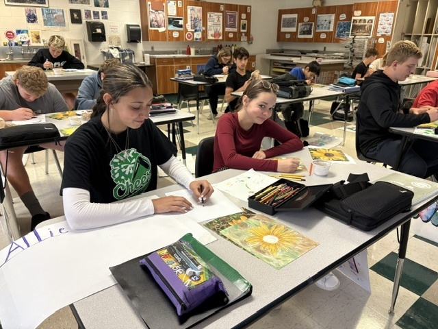 students painting in a classroom