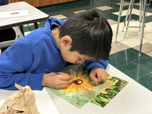 students painting in a classroom