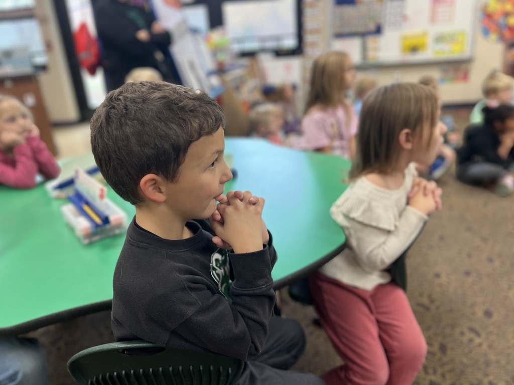 Students in a classroom looking excites