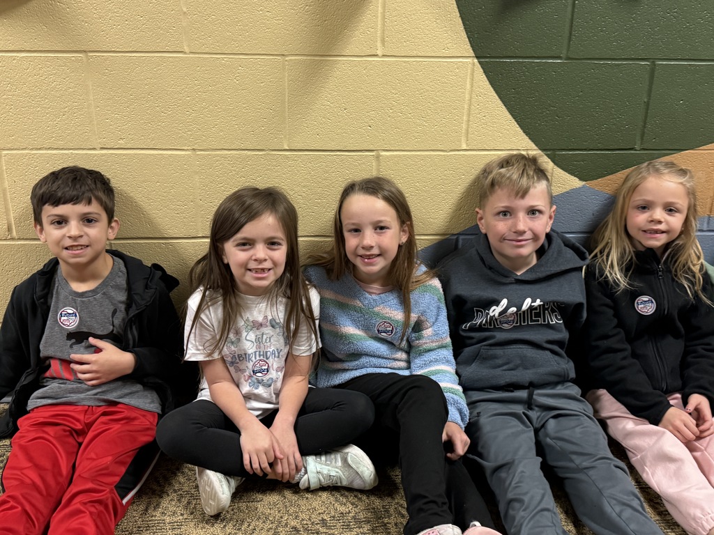 students posing with their I voted stickers