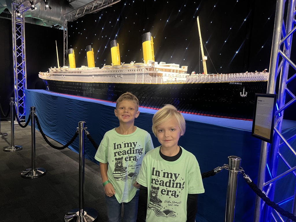 2 students standing in front of the Lego Titanic