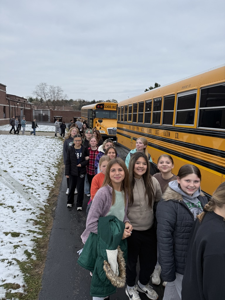 students loading the bus for camp