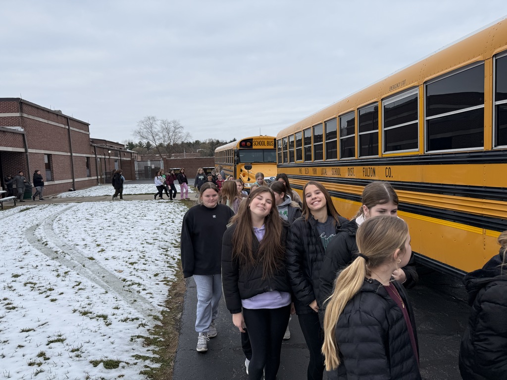 students loading the bus for camp