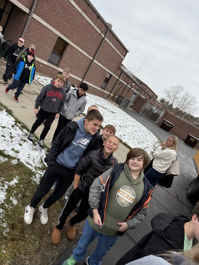 students loading the bus for camp
