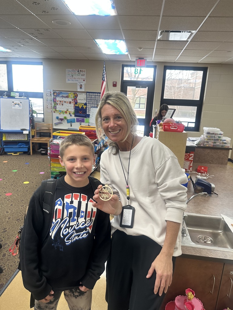 student posing with a Christmas ornament