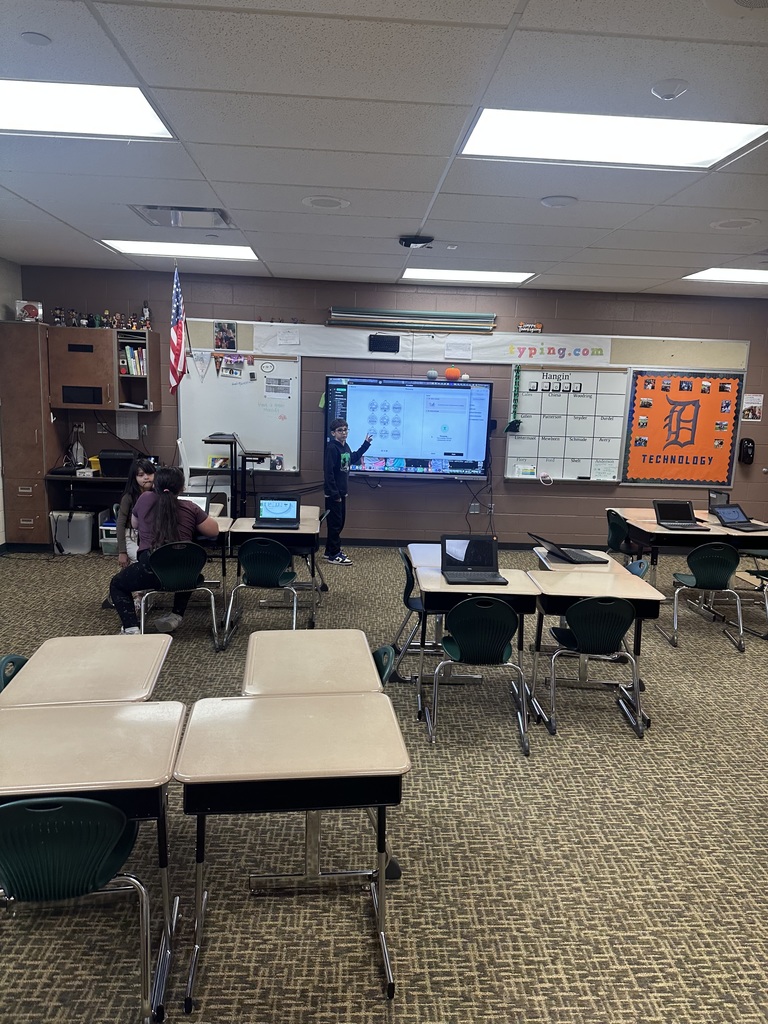 student posing with a Christmas ornament