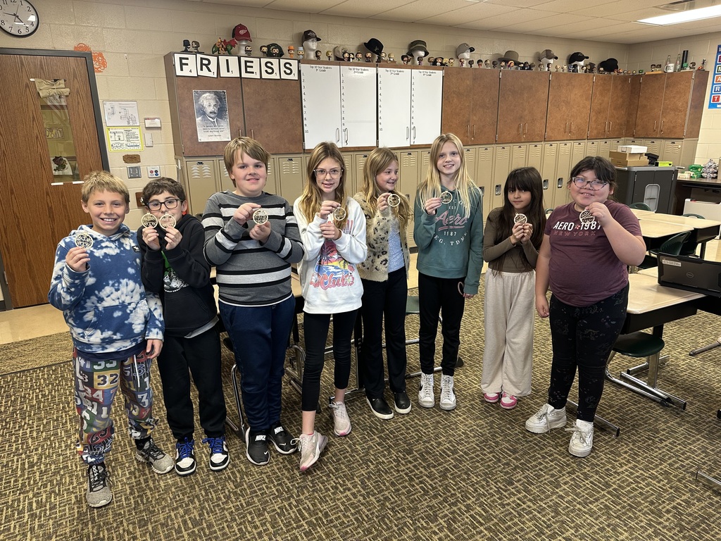 student posing with a Christmas ornament