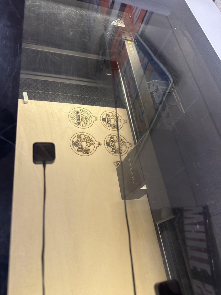 student posing with a Christmas ornament