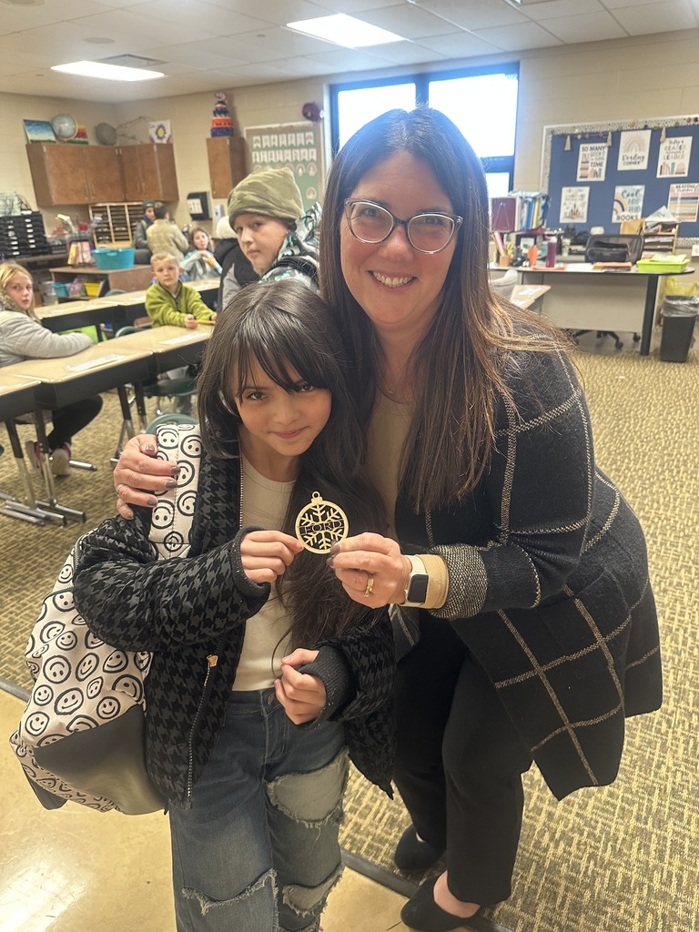 student posing with a Christmas ornament