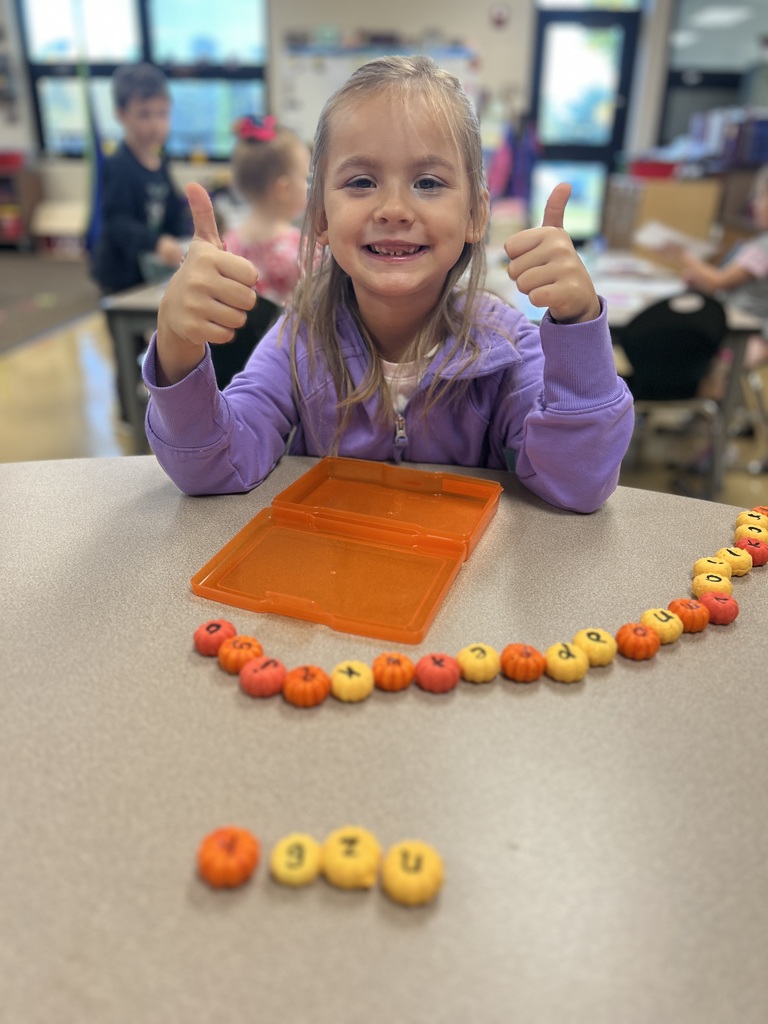 students carving pumpkins in a classroom