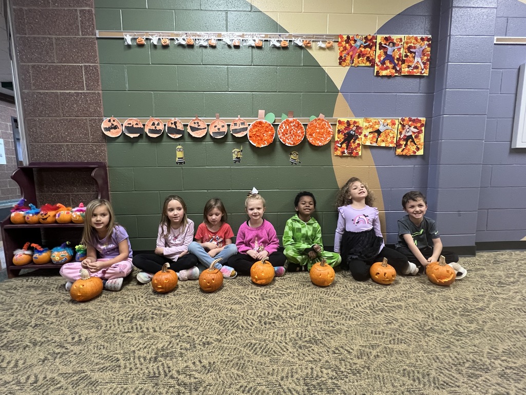 students carving pumpkins in a classroom