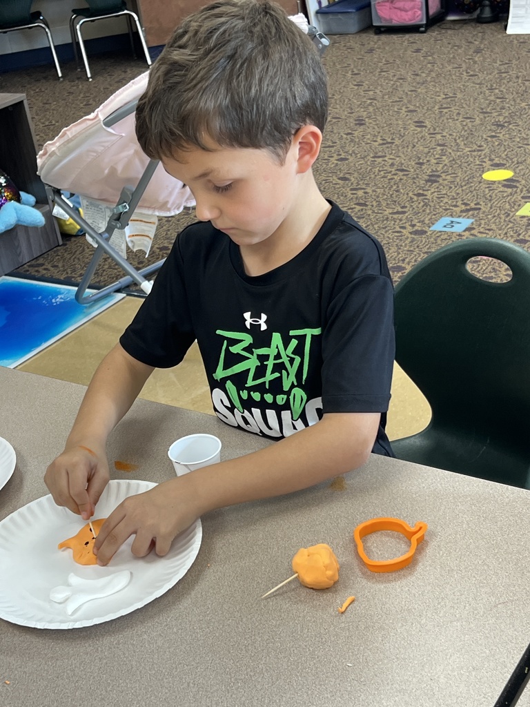 students carving pumpkins in a classroom