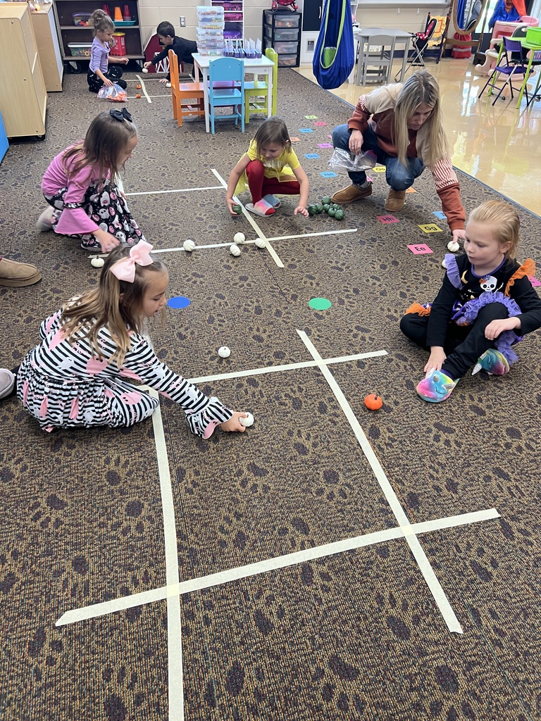 students carving pumpkins in a classroom
