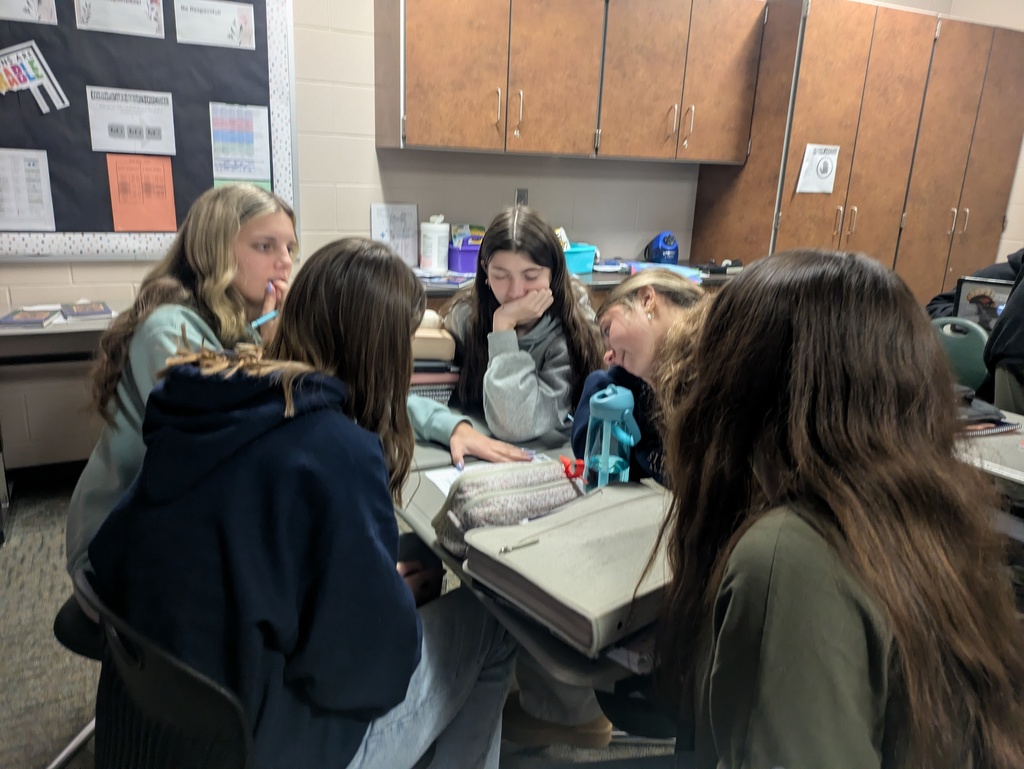 HS students working through an escape room in class