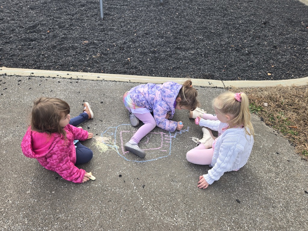 Students drawing with chalk outside
