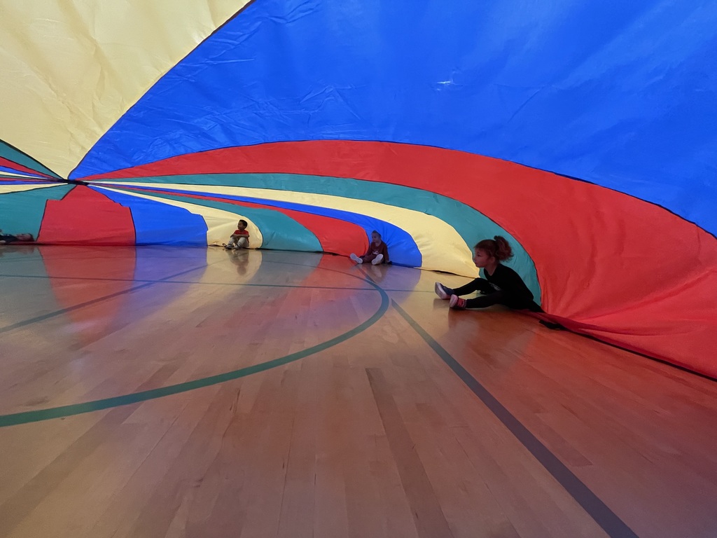 students playing with a parachute in PE class