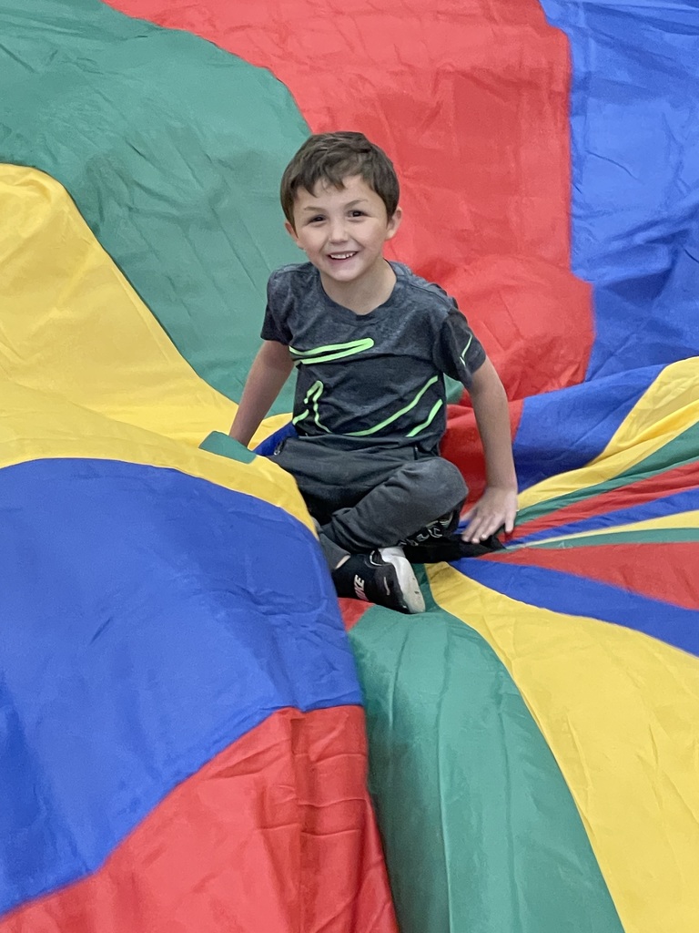 students playing with a parachute in PE class