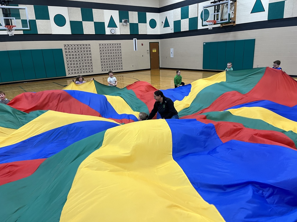 students playing with a parachute in PE class