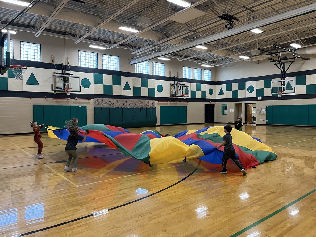 students playing with a parachute in PE class