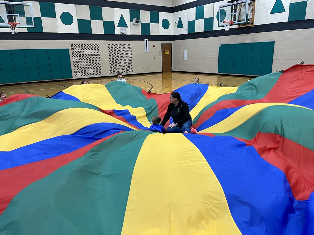 students playing with a parachute in PE class