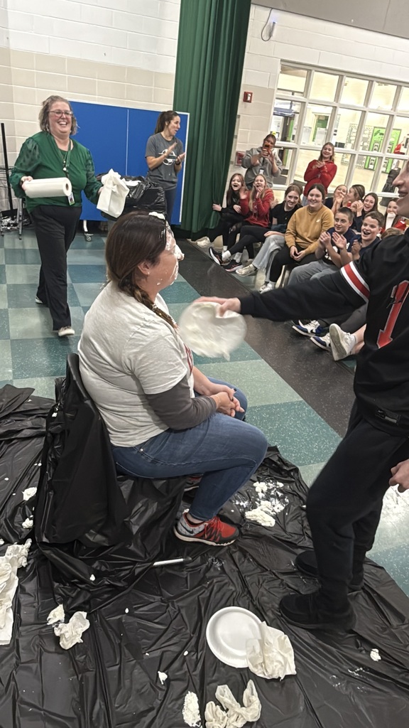Students throwing pies in teacher's faces