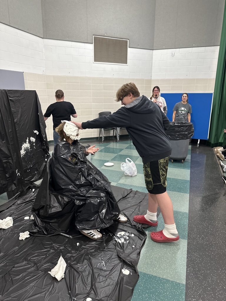 Students throwing pies in teacher's faces
