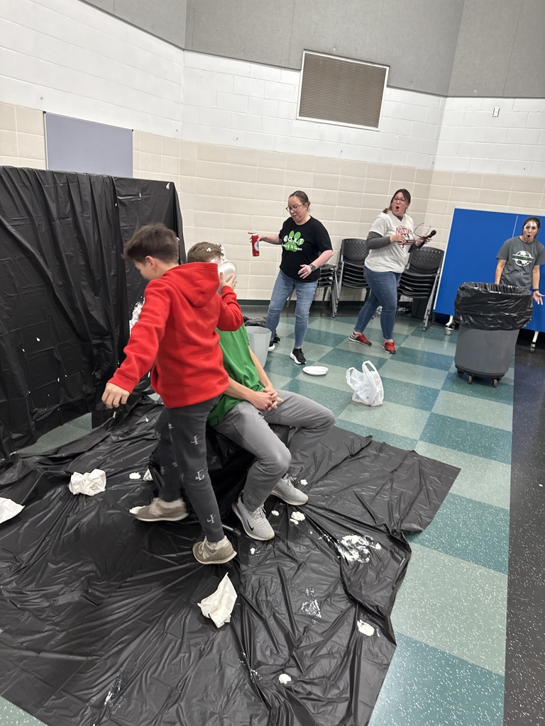 Students throwing pies in teacher's faces