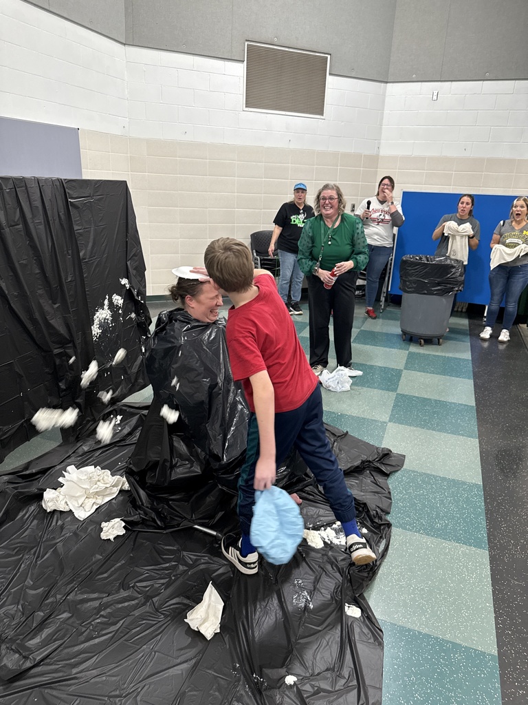 Students throwing pies in teacher's faces