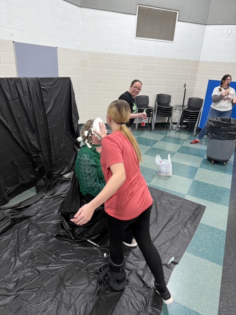 Students throwing pies in teacher's faces