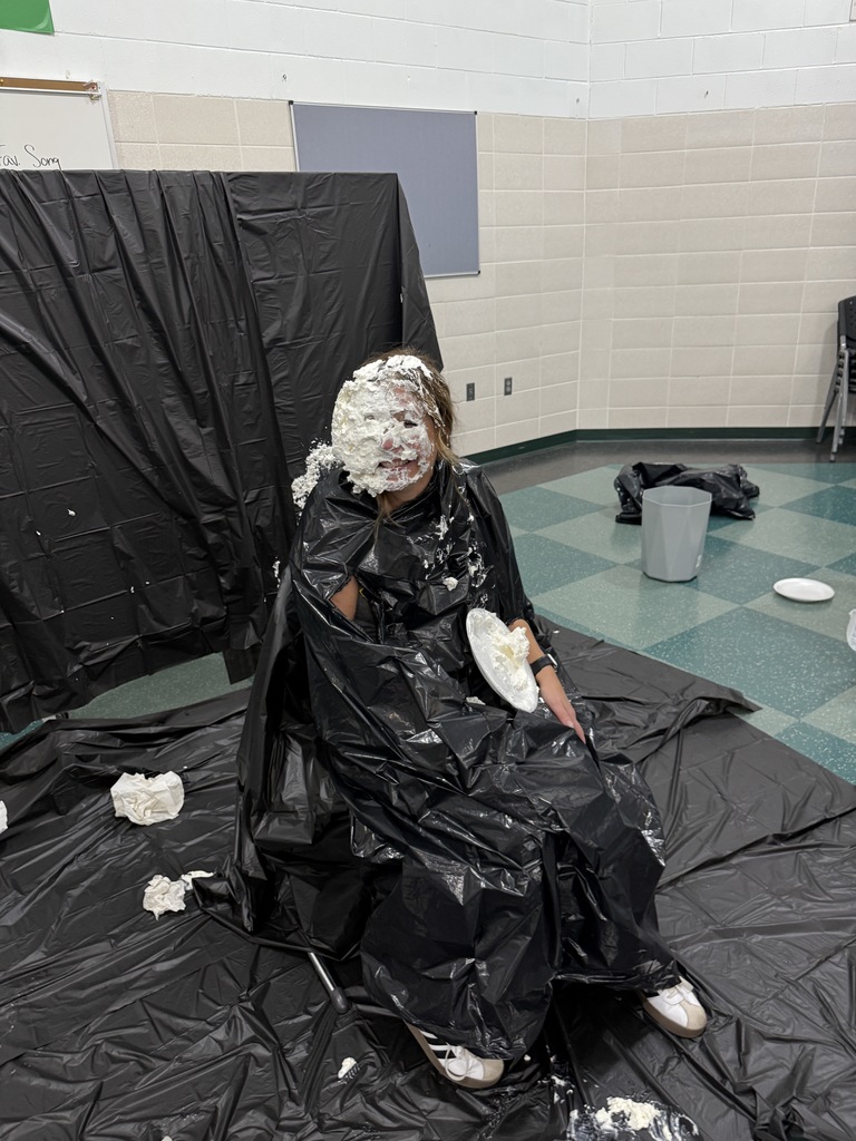 Students throwing pies in teacher's faces