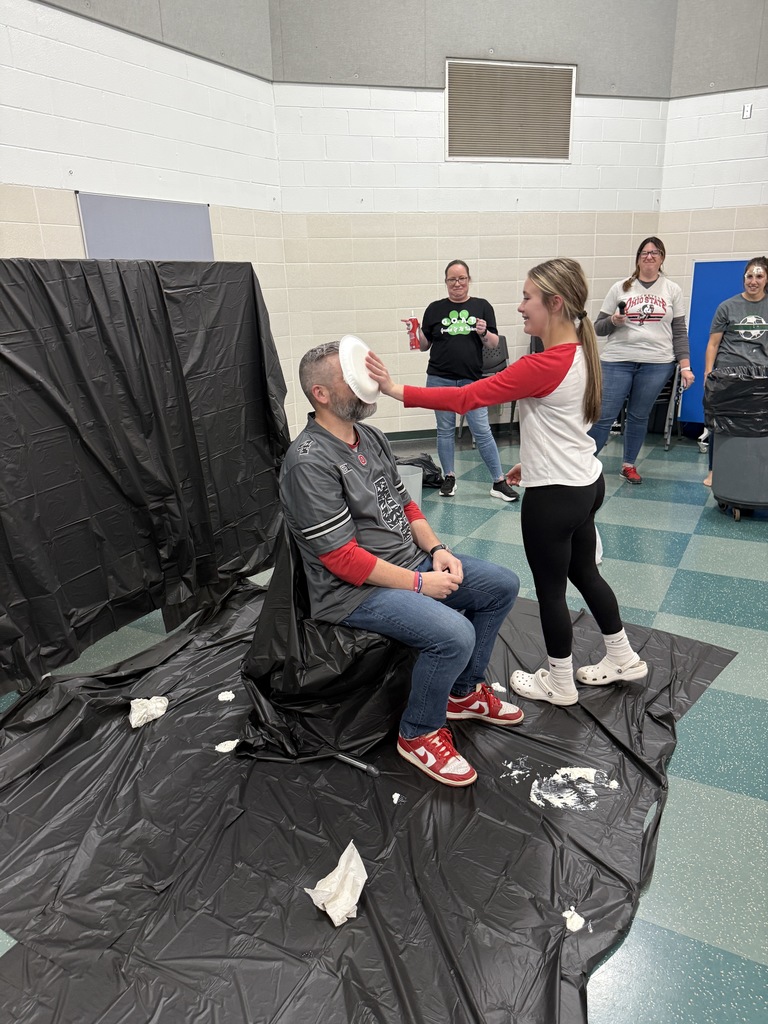 Students throwing pies in teacher's faces