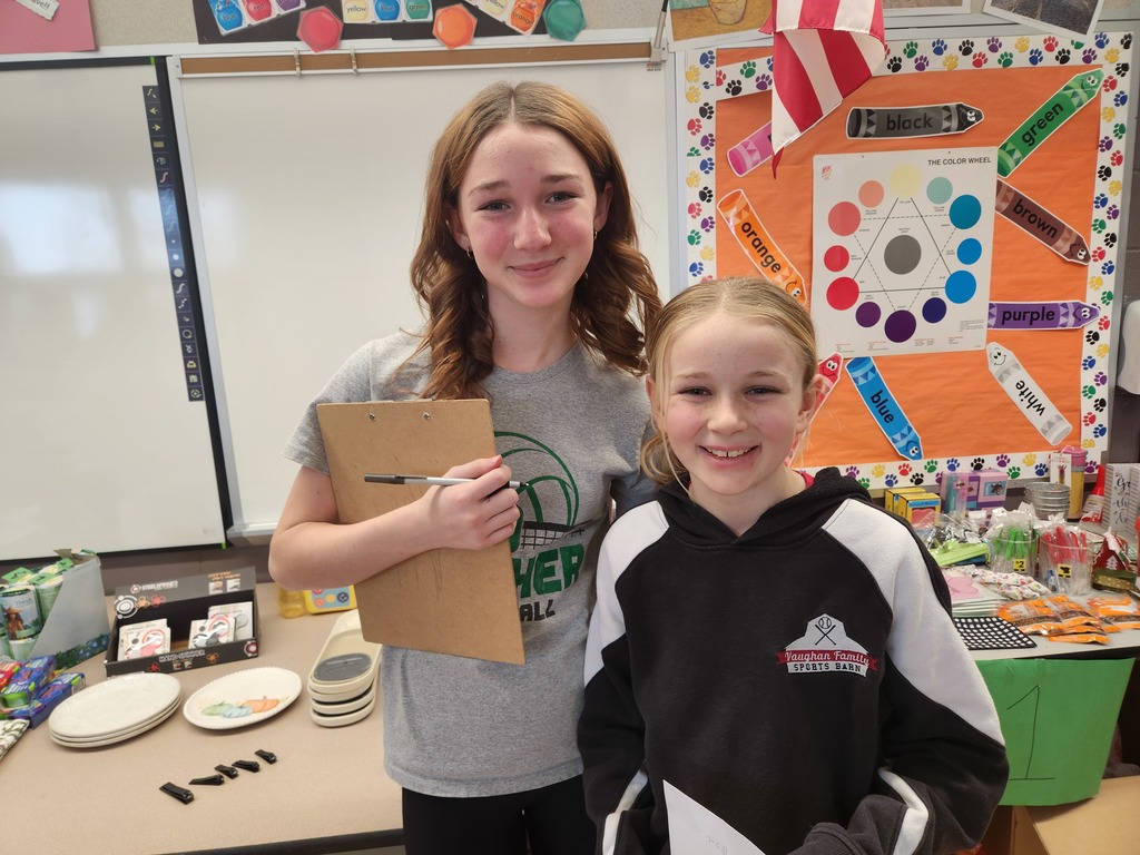 students helping out with a Santa shop at a school