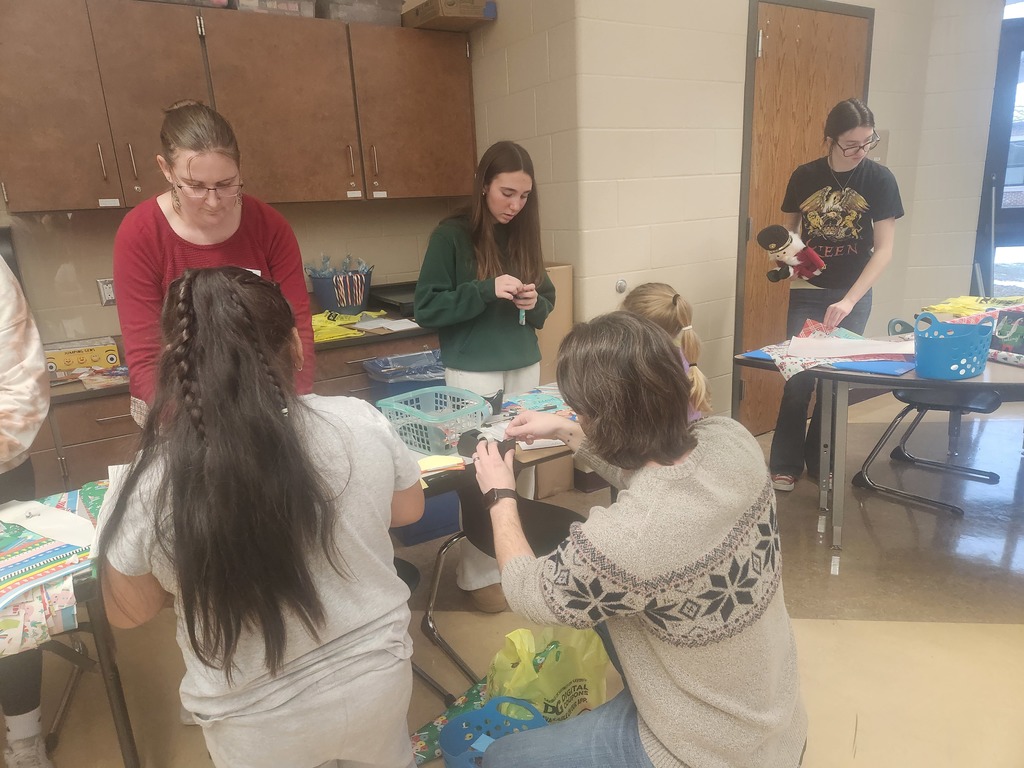 students helping out with a Santa shop at a school