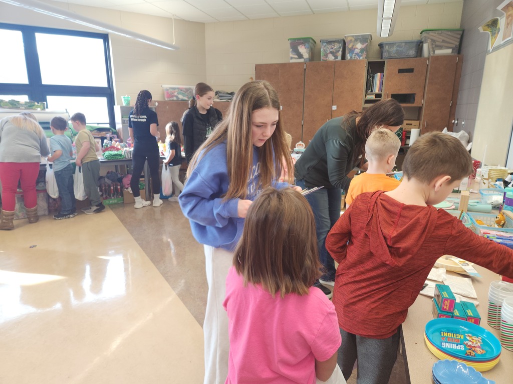 students helping out with a Santa shop at a school