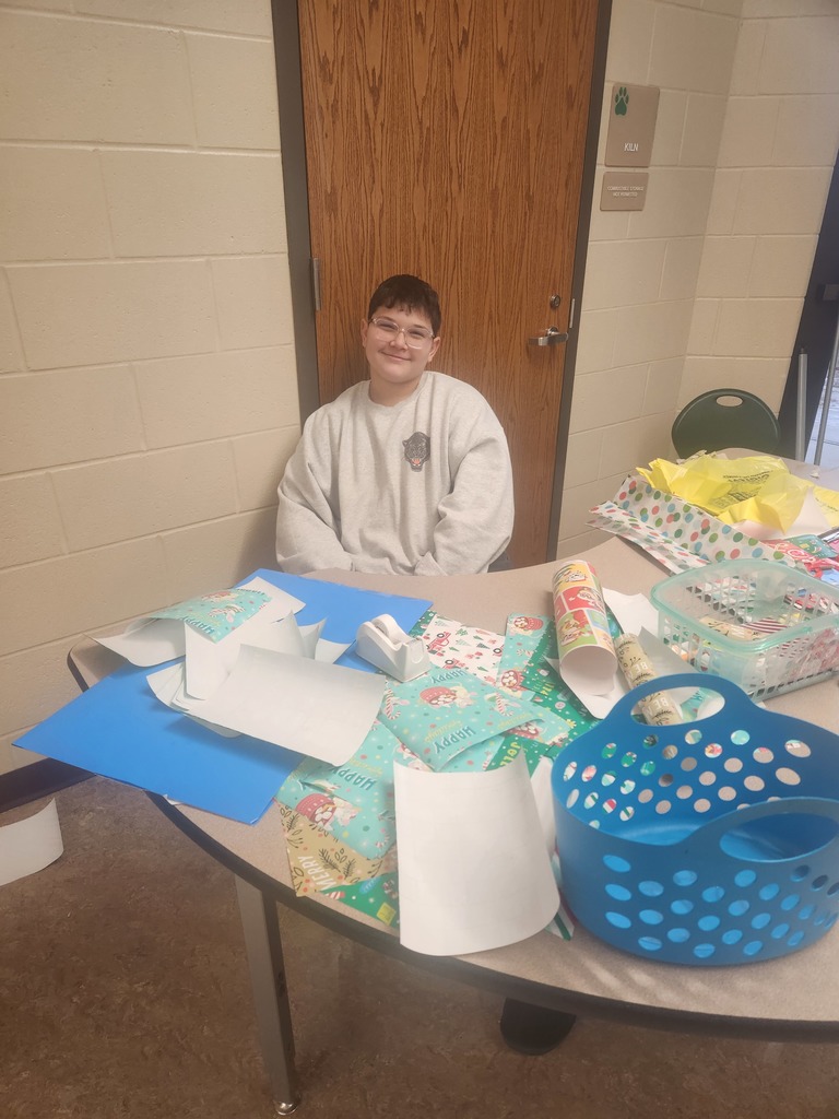 students helping out with a Santa shop at a school