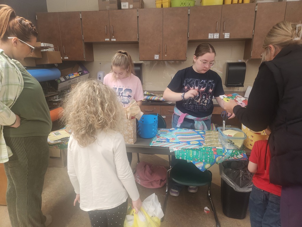 students helping out with a Santa shop at a school