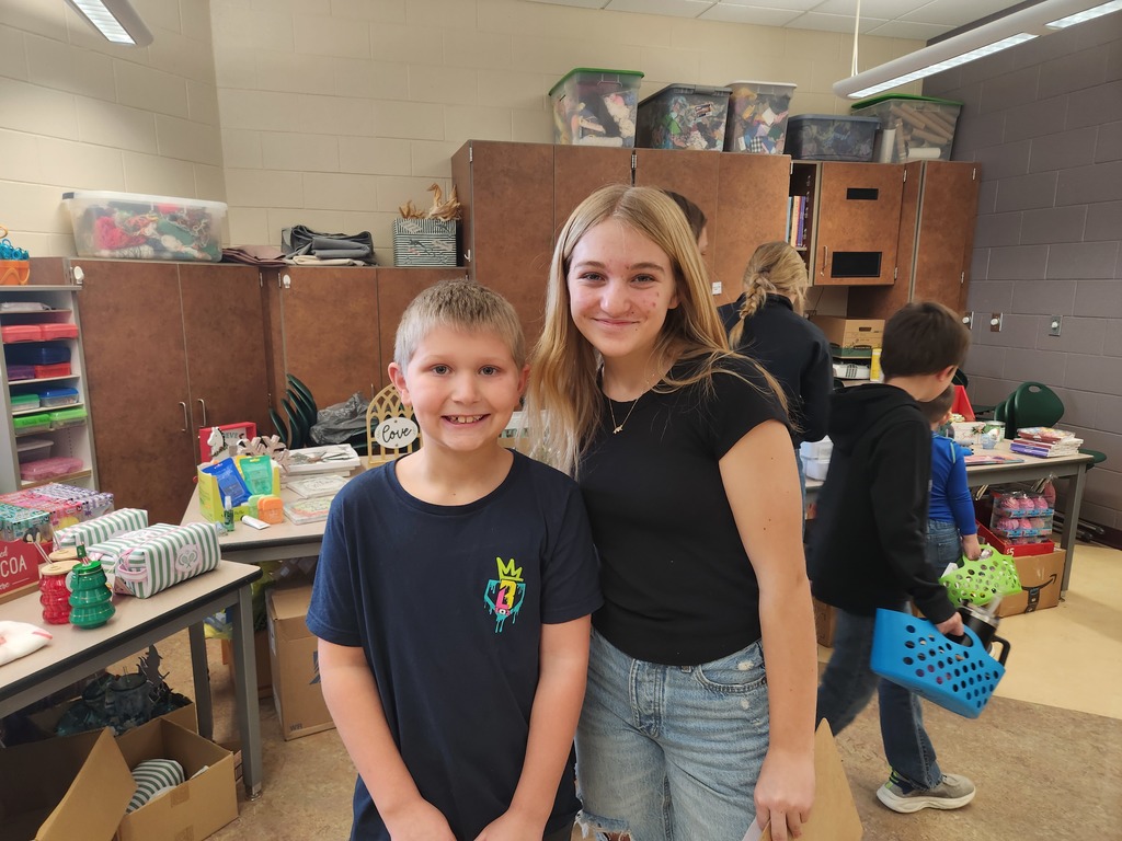 students helping out with a Santa shop at a school