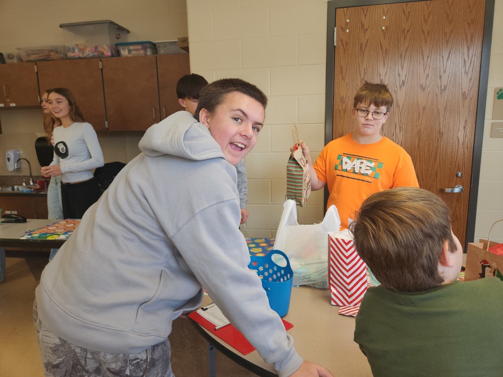students helping out with a Santa shop at a school