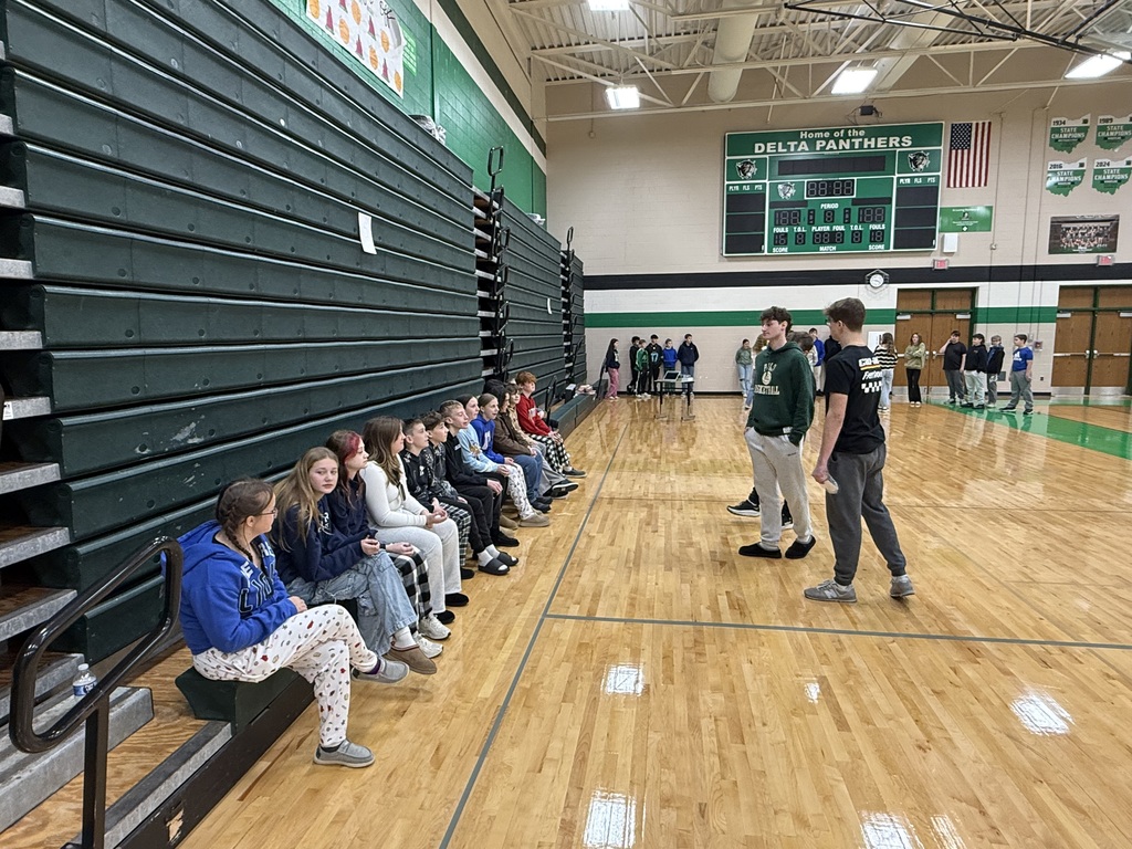 Students sitting on the floor in the gym