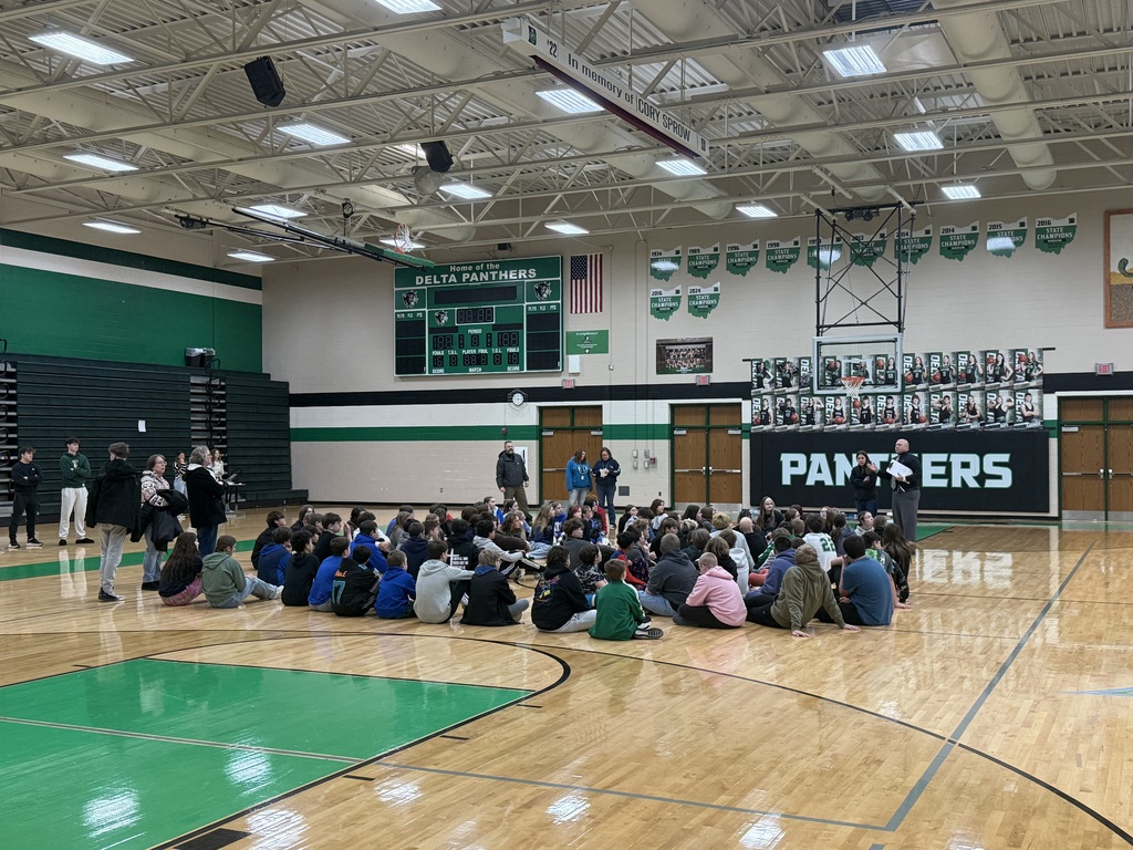Students sitting on the floor in the gym
