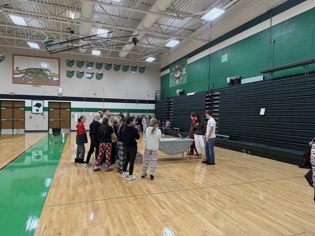 Students sitting on the floor in the gym