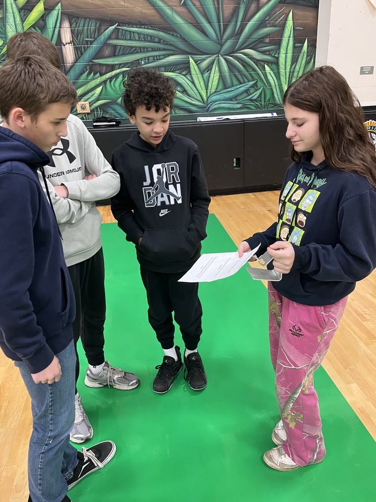 students presenting in a gym