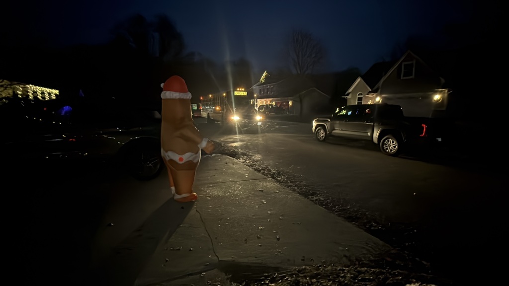 A bus riding by Christmas lights