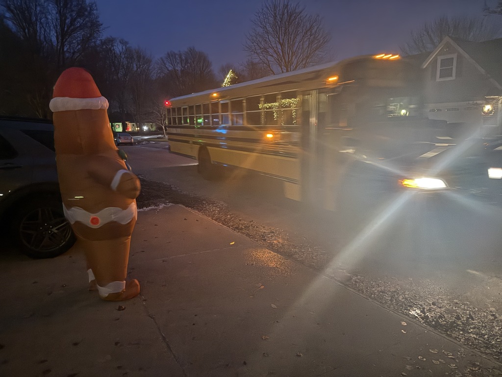 A bus riding by Christmas lights