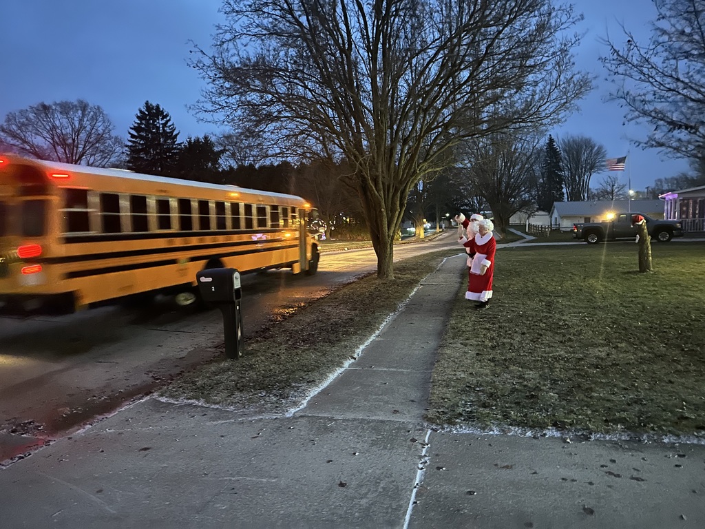 A bus riding by Christmas lights
