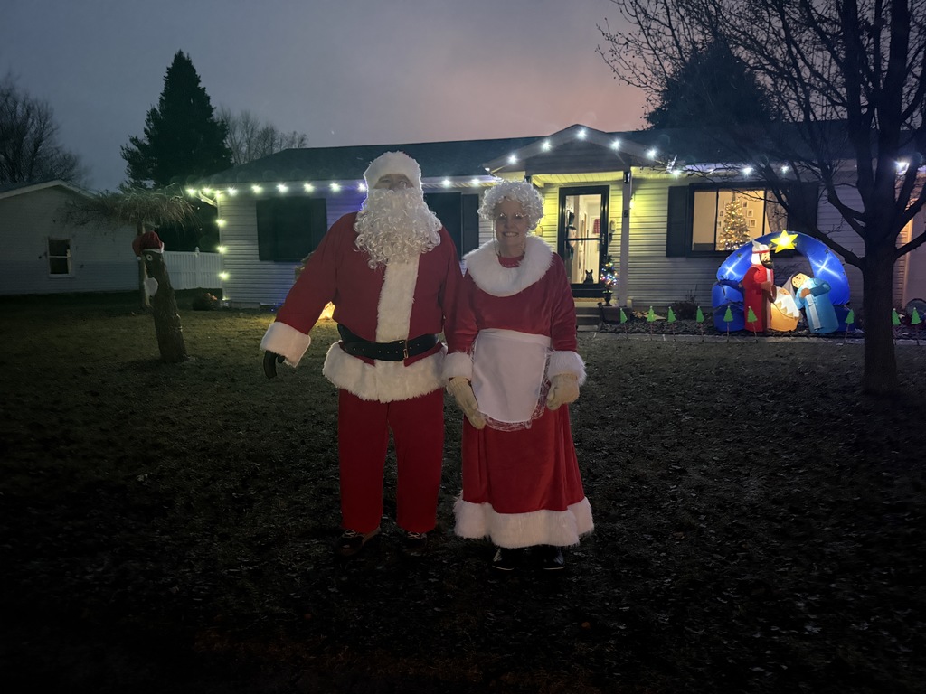 A bus riding by Christmas lights