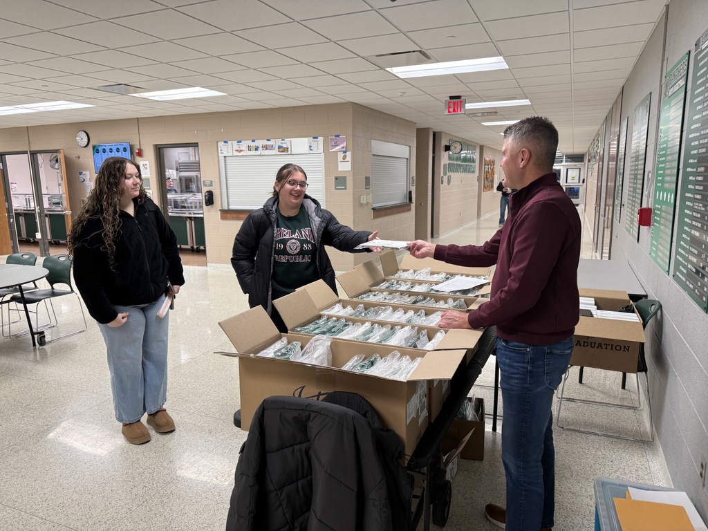Students picking up graduation materials